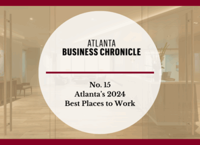 A graphic with Atlanta Business Chronicle and No. 15 Atlantas 2024 Best Places to Work in bold text over a blurred office lobby background with a red border.