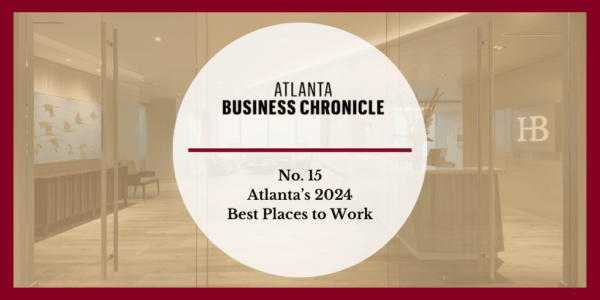 A graphic with Atlanta Business Chronicle and No. 15 Atlantas 2024 Best Places to Work in bold text over a blurred office lobby background with a red border.