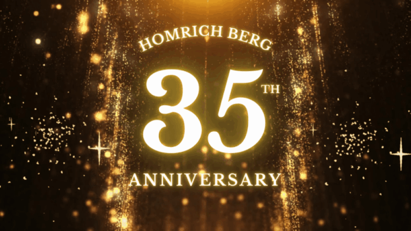 Glowing gold text reads “Homrich Berg 35th Anniversary” against a sparkling, festive golden background with falling glitter and light effects.